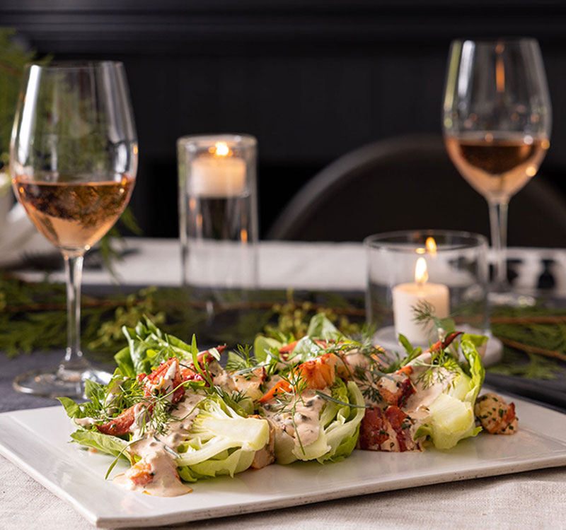 Lobster salad on table with wine