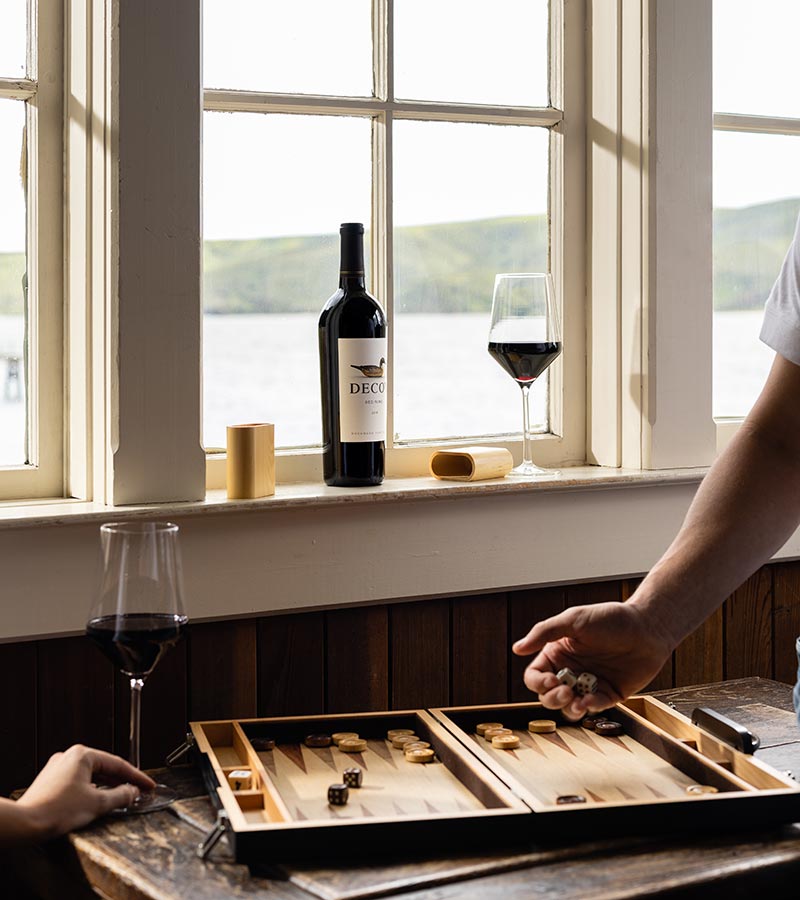Decoy Red wine with couple playing a board game