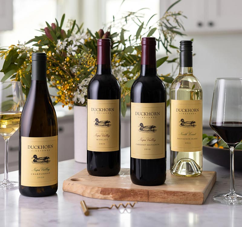 Four bottles of Duckhorn Vineyard wines on a counter