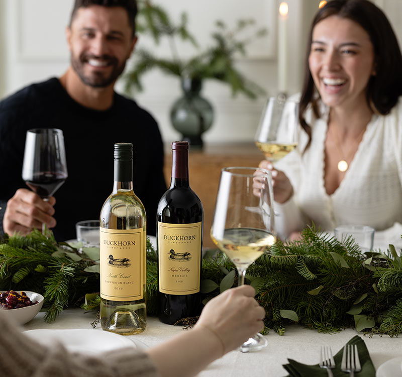 Two bottles of Duckhorn Vineyard wines on a Christmas table