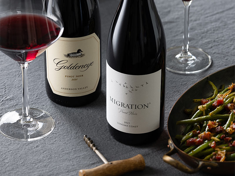 Duckhorn Portfolio Pinot Noir on a table with green beans