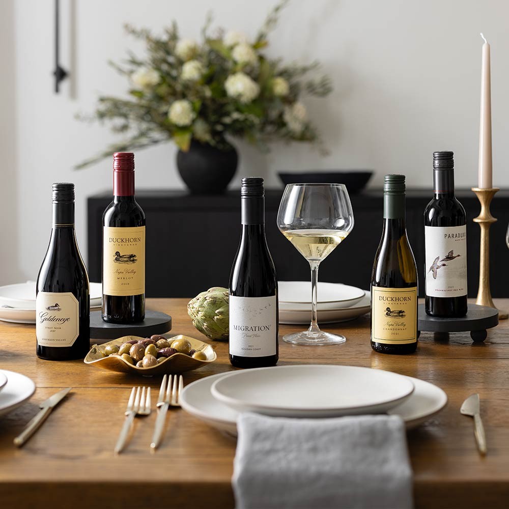 Half bottles of Duckhorn, Paraduxx, Goldeneye, Migration wines on a table