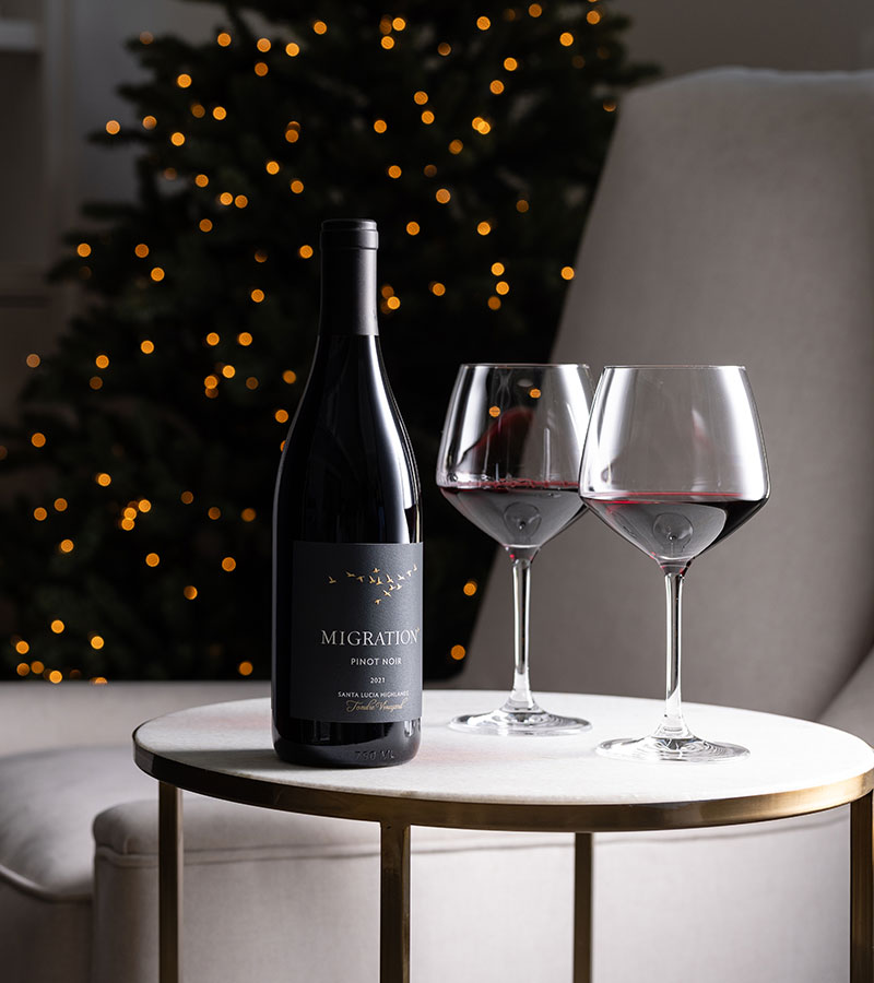 Migration pinot noir on a table with two glasses