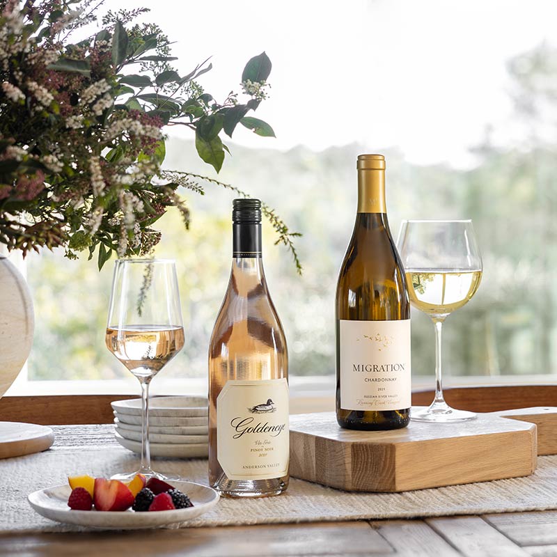 Two Bottles of the Duckhorn Portfolio wines on a table with berries