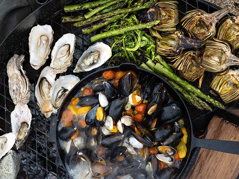 Seafood and veggies on outdoor grill cooking