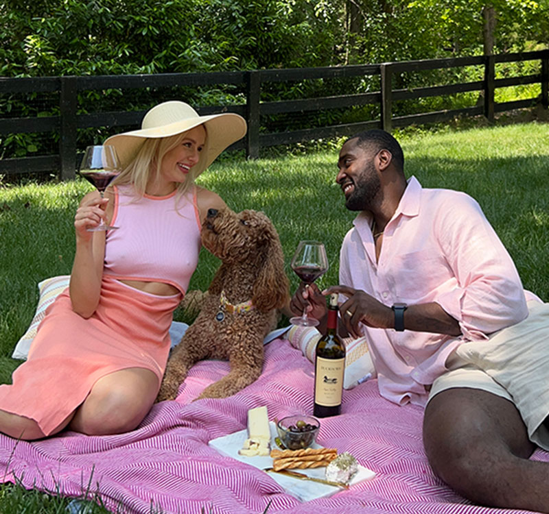 A couple having a picnic with Duckhorn Wine